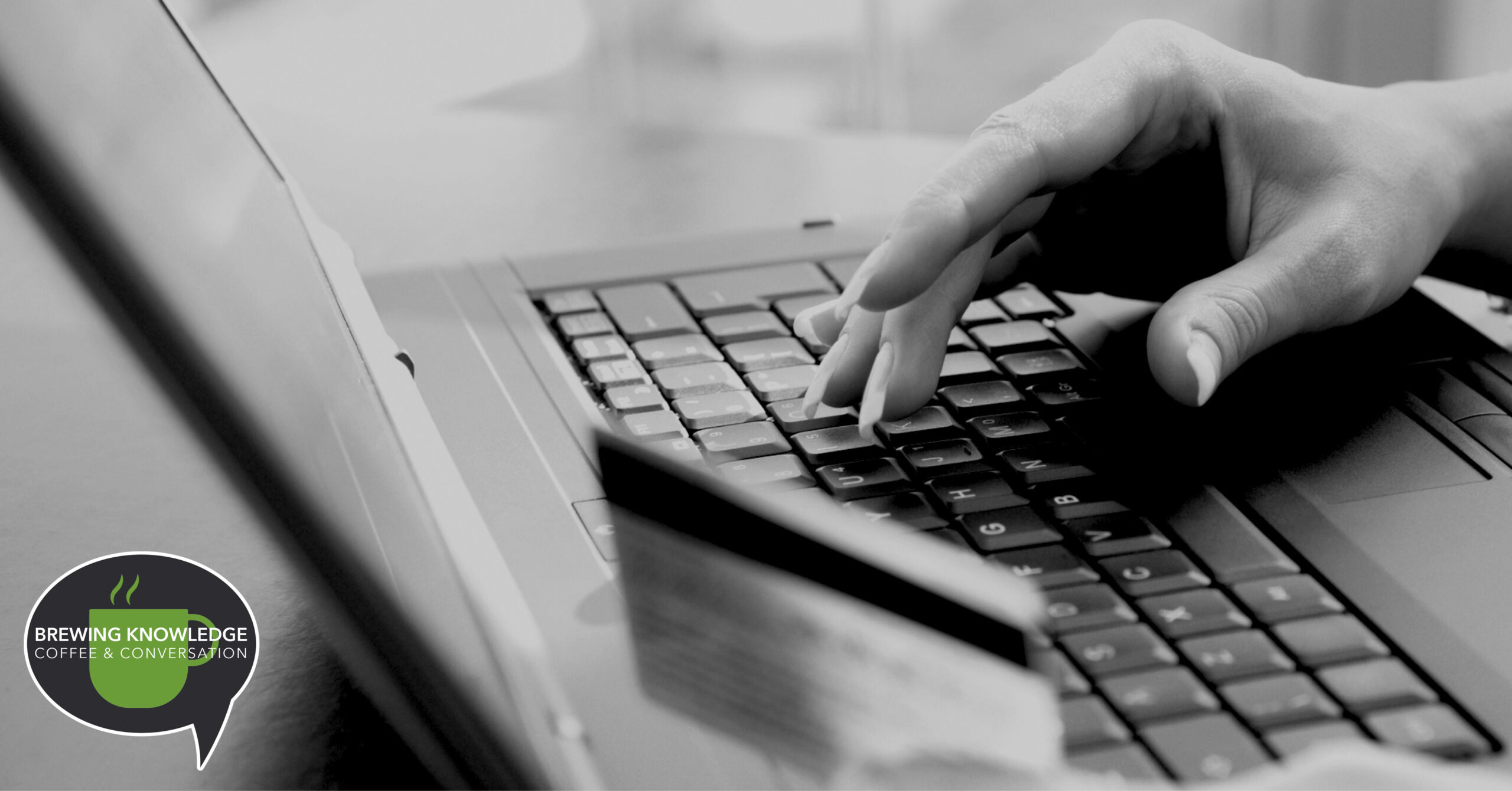 Person using laptop and holding a credit card